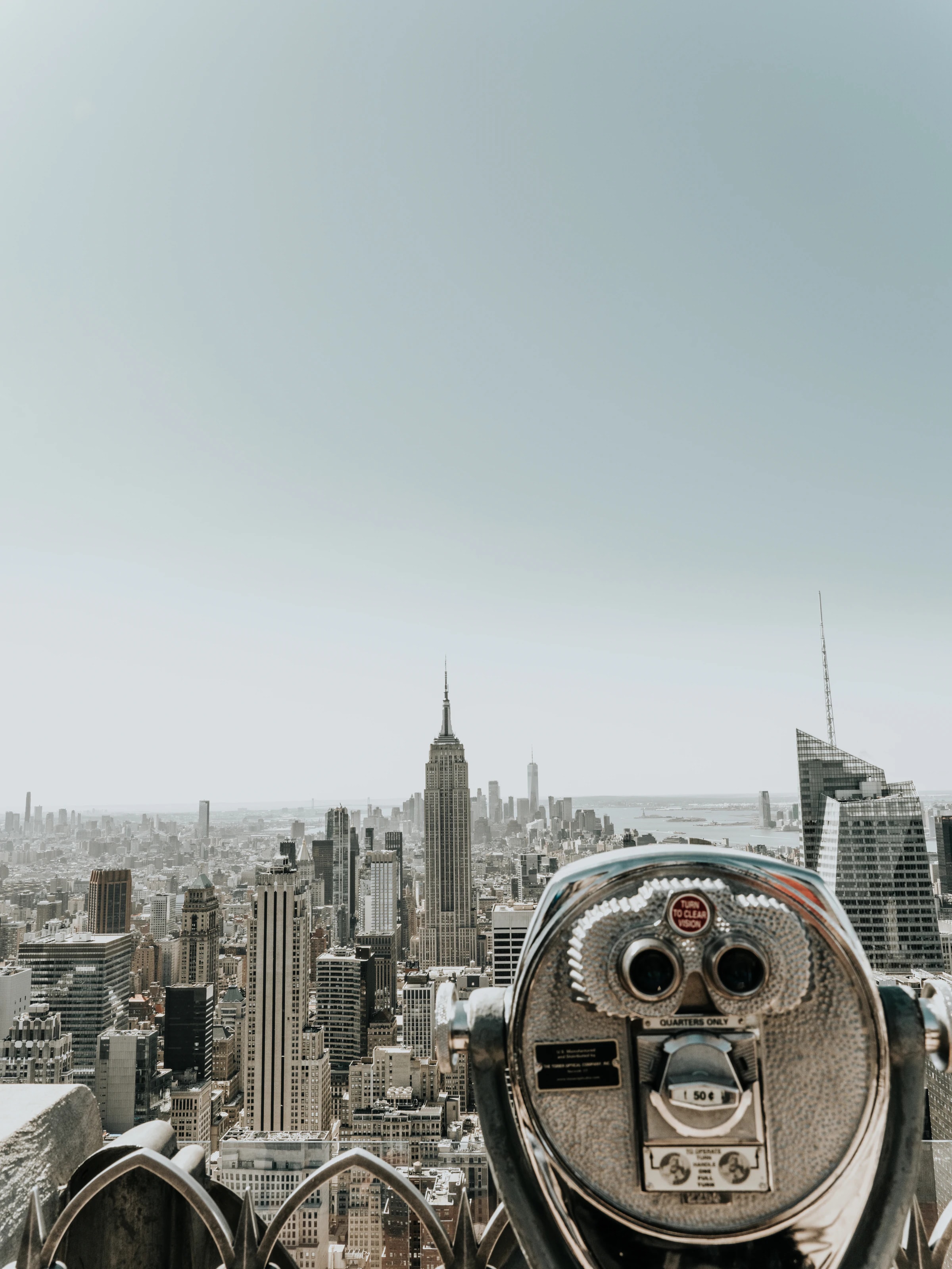 Manhattan skyline with the Empire State Building, a coin-operated viewer in the foreground, New York